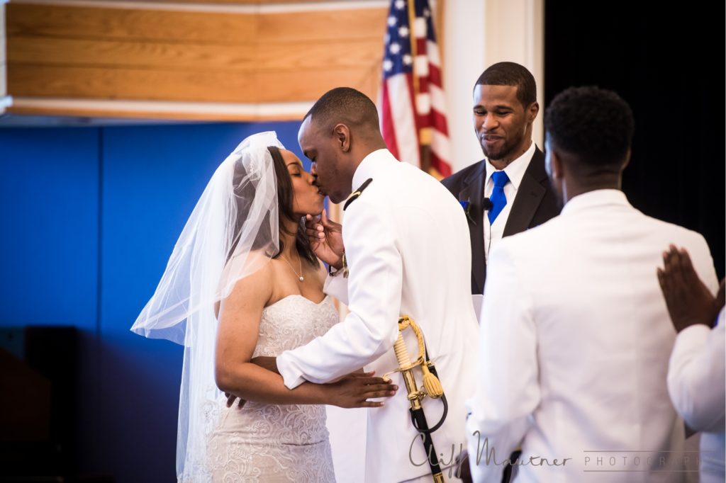 The bride and groom share a kiss to complete the wedding ceremony. 