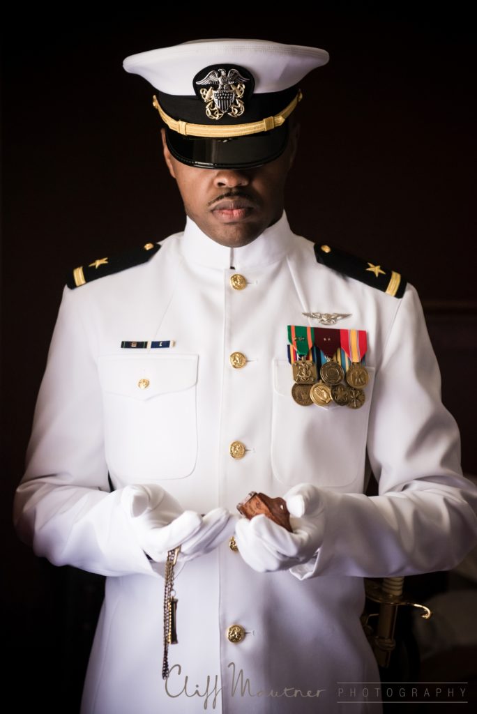 The groom dressed in his Naval officer uniform on his wedding day before the ceremony. 